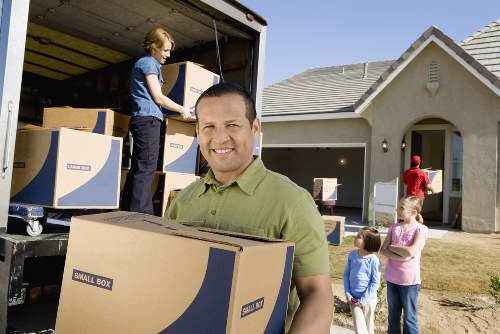 Professional movers efficiently packing items